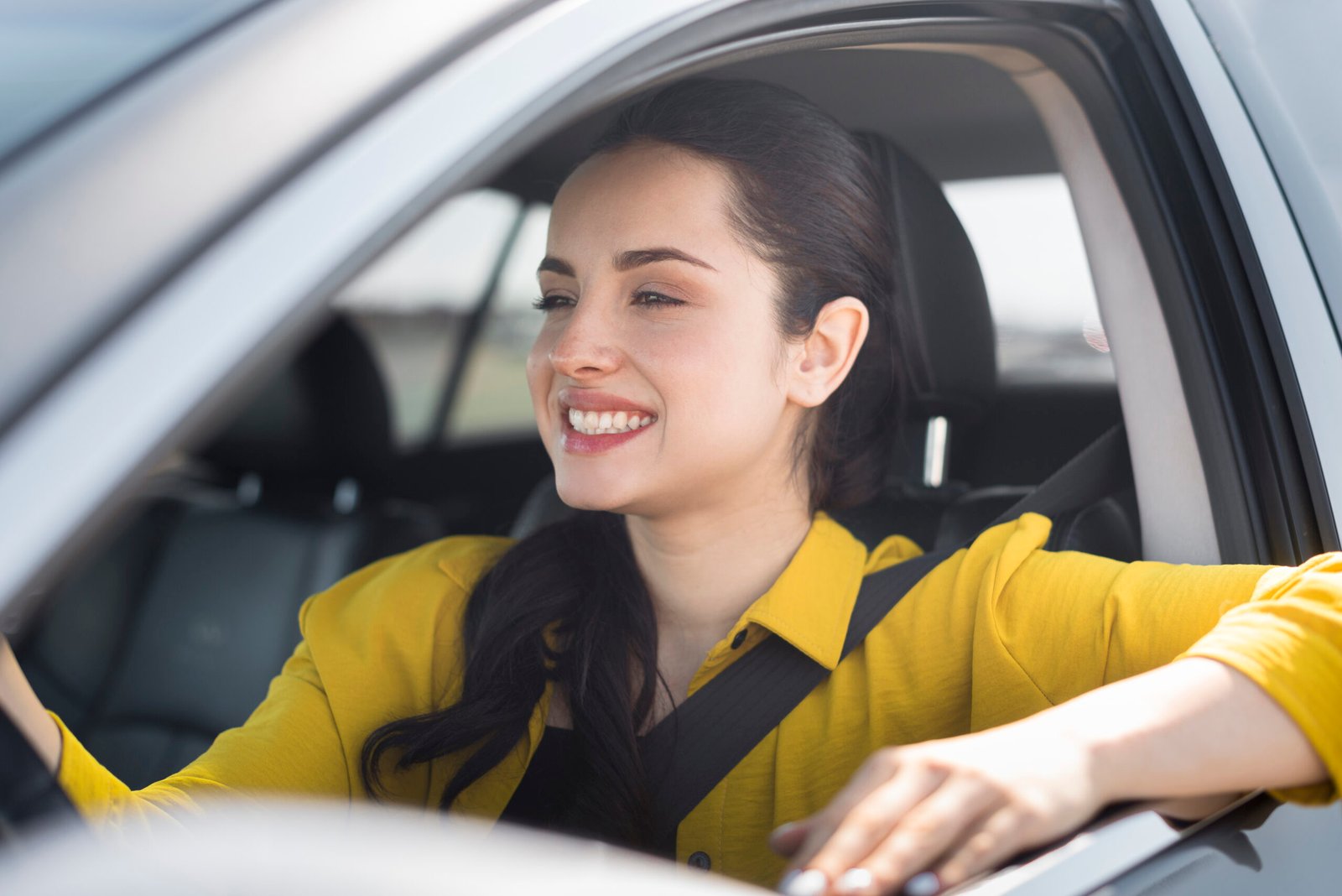 smiley woman having her seat belt